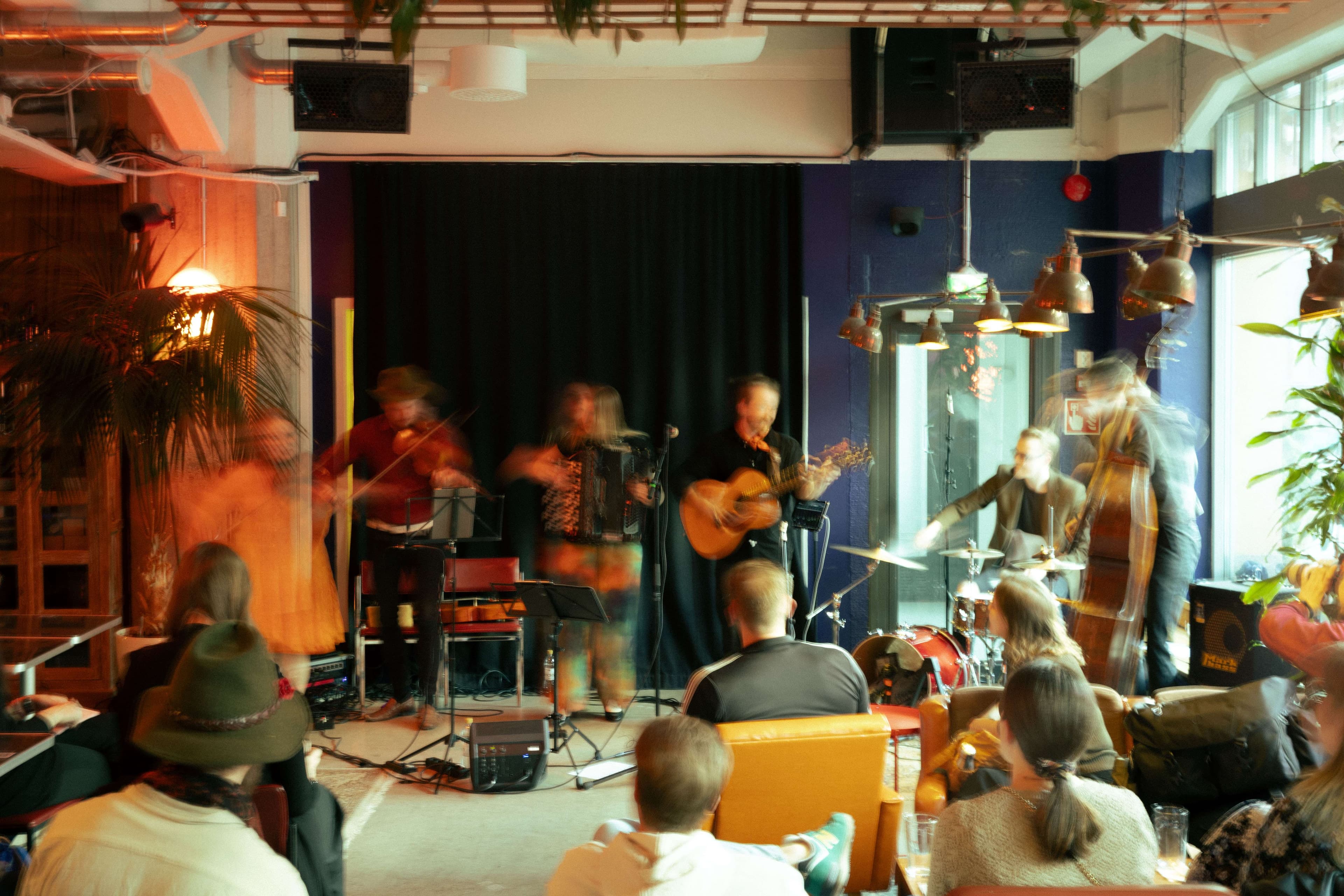 HUIPPU tip jar: a group of people playing music in a room